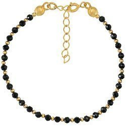 Gold-plated silver bracelet made of natural black spinel stones interleaved with 3 mm gold-plated beads