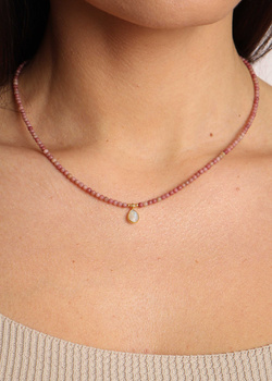 Necklace made of natural rhodonite stones, pendant rock crystal