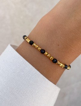 Bracelet on an elastic band with khaki cubic zirconia and natural pearl